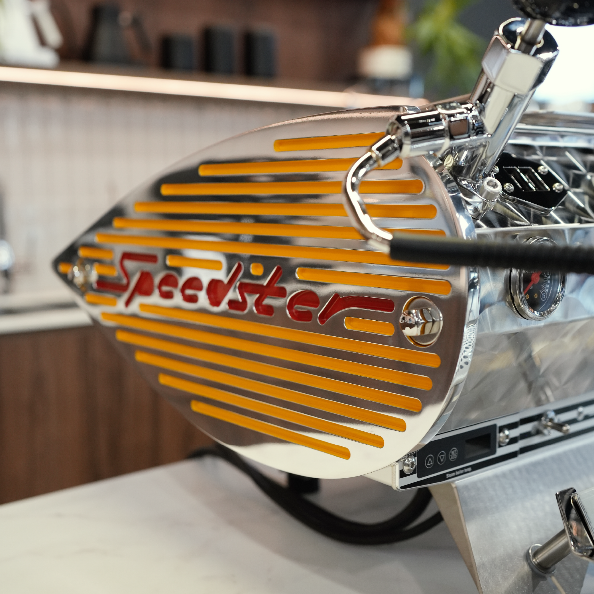 Kees Van Der Westen Speedster. Close up of custom yellow racing stripe side panel on countertop.